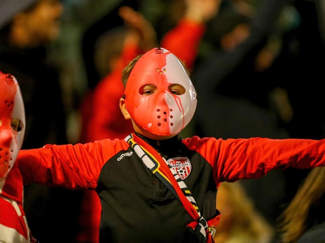 These masked young Derry City fans are enjoying the atmosphere at Dalymount Park.