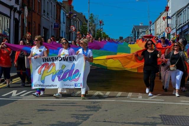 The colourful Inishowen Pride Parade making it way along Lower Main Street in Buncrana last year. Photograph: George Sweeney. DER2224GS – 022
