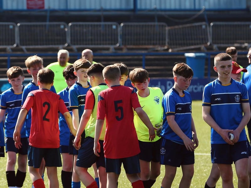 Lisneal players congratulate St Columb's College after the trophy presentation.