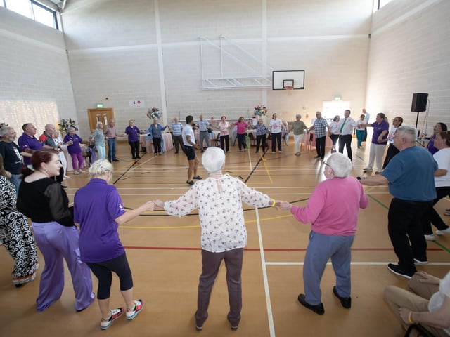 Entertainer Micky Doherty hs everyone on the dance floor at Tuesday's DEEDS Tea Party in Creggan. (Photos: Jim McCafferty Photography) : .