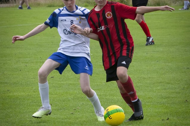 A clash for possession during Monday’s u-13 game between Hillsborough Boys and St. John’s Athletic (Roscommon) at Templemore Sports Complex. (Photos: Jim McCafferty Photography)