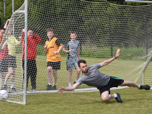Mr Hargan showcasing his goalkeeper skills during the penalty kick competition at Steelstown PS Sports Day.