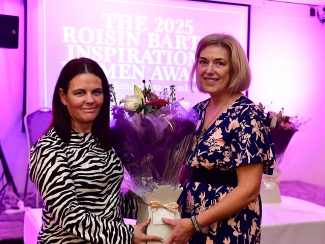 Monica McGuigan receiving her presentation from Aine Doherty, daughter of Roisin Barton.