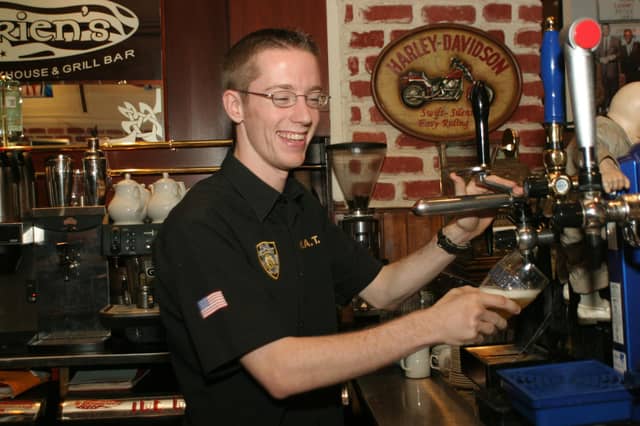Barman, David Harkin, pulling a pint for one of the regulars at O'Briens.