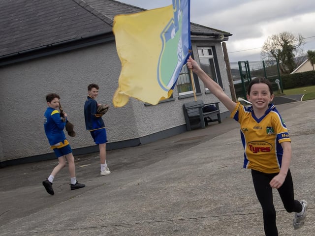 One of the pupils  from Scoil Naomh Mura, Burnfoot flyiing the flagt for the Beart GAC hurlers who will take on Lavey in the Ulster Junior Championship final at Celtic Park on Saturday.