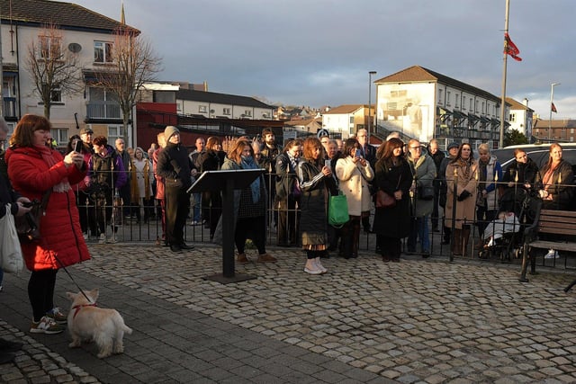Relatives are joined by people at the Bloody Sunday monument at Joseph’s Place on Tuesday afternoon for a one minute silence on the 52nd anniversary of the Bloody Sunday massacre. Photo: George Sweeney.