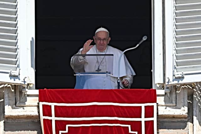 Pope Francis addresses the crowd from the window of the apostolic palace overlooking St Peter's Square, during his Regina Coeli prayer, on Easter Monday, at the Vatican, on April 10, 2023. (Photo by Andreas SOLARO / AFP) (Photo by ANDREAS SOLARO/AFP via Getty Images)