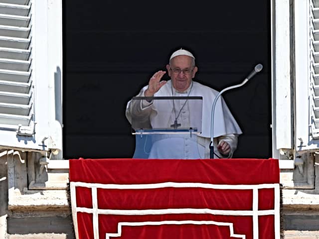 Pope Francis addresses the crowd from the window of the apostolic palace overlooking St Peter's Square, during his Regina Coeli prayer, on Easter Monday, at the Vatican, on April 10, 2023. (Photo by Andreas SOLARO / AFP) (Photo by ANDREAS SOLARO/AFP via Getty Images)