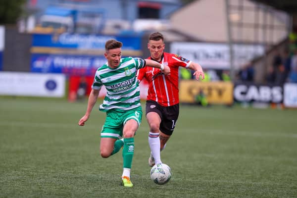 Shamrock Rovers captain Ronan Finn and Derry City's Ben Doherty in a race for the ball during the first half of the clash at Brandywell. Photograph by Kevin Moore.