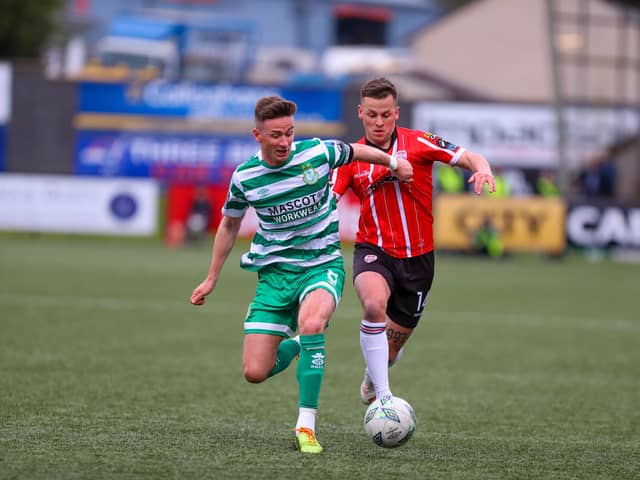 Shamrock Rovers captain Ronan Finn and Derry City's Ben Doherty in a race for the ball during the first half of the clash at Brandywell. Photograph by Kevin Moore.