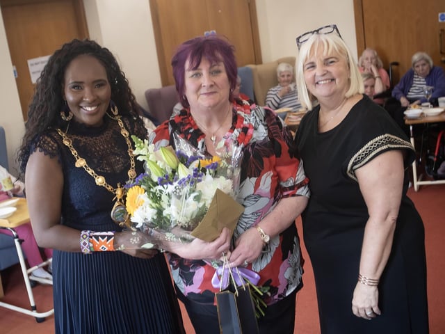 A member of staff being presented with an award from the Mayor, Lillian Seenoi-Barr for 25 years of service at Longfield Care Home on Thursday afternoon. On right is Louise Carroll, Home Manager, Longfield Care Home, part of the Healthcare Ireland Group.