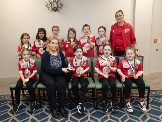 Maiden City u-9s receive the Summer Plate trophy from Kerri Pyne at the D&D Youth FA awards at the Waterfoot Hotel on Sunday night last. Included is coach Jennifer Browne. (Photos: Jim McCafferty Photography)