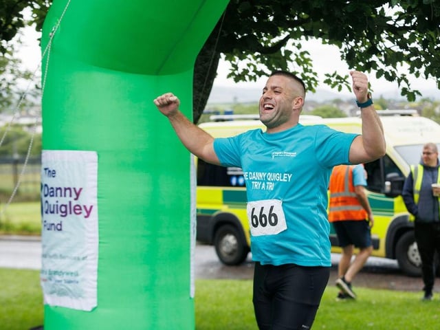 Crossing the line at the Bogside & Brandywell Health Forum Danny Quigley 'Try-a-Tri' event. (Photo: Micam Photography)