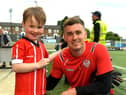 Derry City fan Evan Collins celebrates his sixth birthday with his Brandywell hero Brian Maher who led him out onto the pitch as mascot ahead of Friday's big win against UCD.