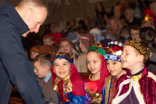 Fr. Sean O'Donnell congratulates the children on their performances in the Nativity on Wednesday.