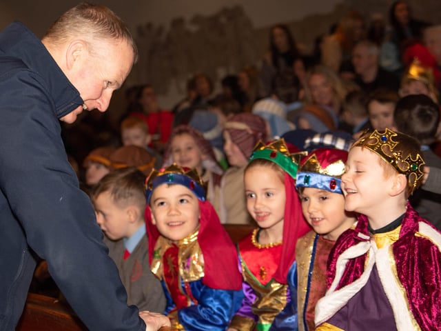 Fr. Sean O'Donnell congratulates the children on their performances in the Nativity on Wednesday.
