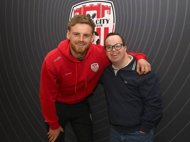 Candystripe fan Michael O'Donohue pictured with Derry City's Rob Slevin at the clu's merchandise outlet in Foyleside Shopping Centre. Photo: George Sweeney