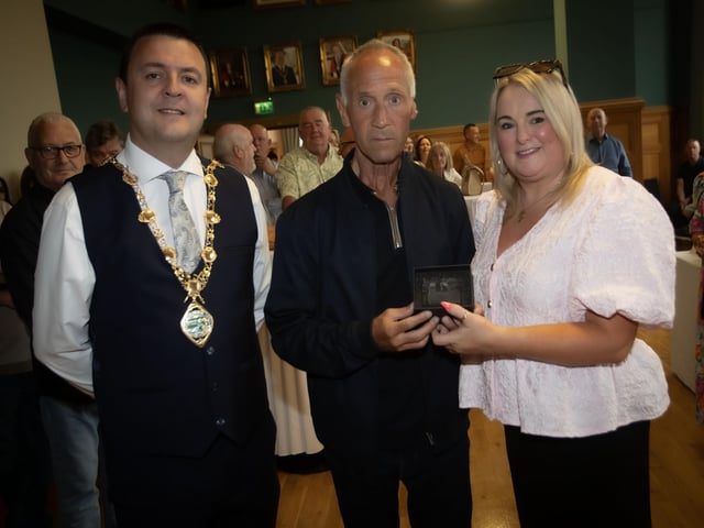 Councillor Sandra Duffy makes a special presentation to Martin Sheehan, Celtic Bar, main sponsors of the Eamonn 'Bronco' Bradley Football Tournament, during a reception in the Guildhall on Friday evening to mark the tournament's 40th anniversary. On left is the Mayor, Ruairi McHugh. (Photos: Jim McCafferty Photography) : .