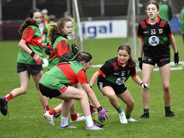 Young footballers from Doire Trasna and Slaughtmanus Under 12 teams play at half-time at the Derry Junior Football Championship Final held in Celtic Park on Sunday afternoon. Photo: George Sweeney