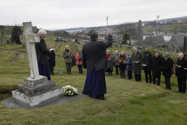 2013: Parishioners from St. Columb's Cathedral in prayer during their annual Easter Pilgrimage to the grave of Cecil Frances Alexander in the City Cemetery on Good Friday. INLS1413-163KM