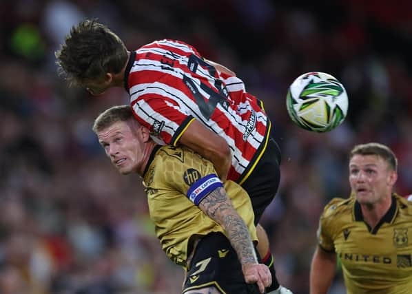 Wrexham skipper James McClean tussles with Sydie Peck of Sheffield United.