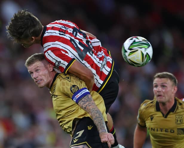 Wrexham skipper James McClean  tussles with Sydie Peck of Sheffield United.