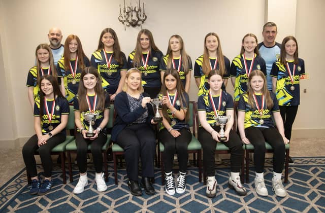 Sion Swifts Ladies Flames u-13s receive the League, Summer Cup and Winter Cup trophies from Kerri Pyne, Derry Credit Union, at the D&D Youth FA awards at the Waterfoot Hotel on Sunday night last. Included are coaches Mark Patton and Tourish. (Photos: Jim McCafferty Photography)