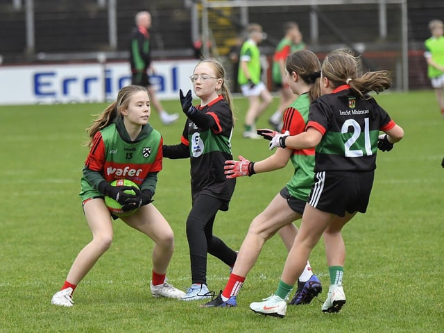 Young footballers from Doire Trasna and Slaughtmanus Under 12 teams play at half-time at the Derry Junior Football Championship Final held in Celtic Park on Sunday afternoon. Photo: George Sweeney