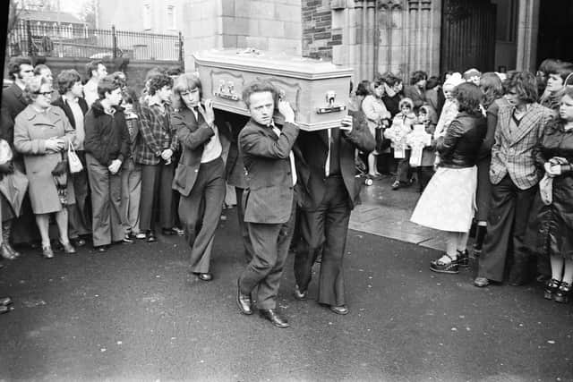 John Toland's coffin is carried from St. Eugene's Cathedral following his Requiem Mass in 1976.
