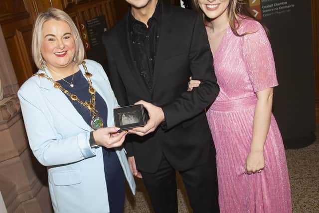Dancing With The Stars finalist, Derryman Damian McGinty pictured receiving his award from the Mayor, Sandra Duffy. On right is Damian’s wife Anna Claire.
