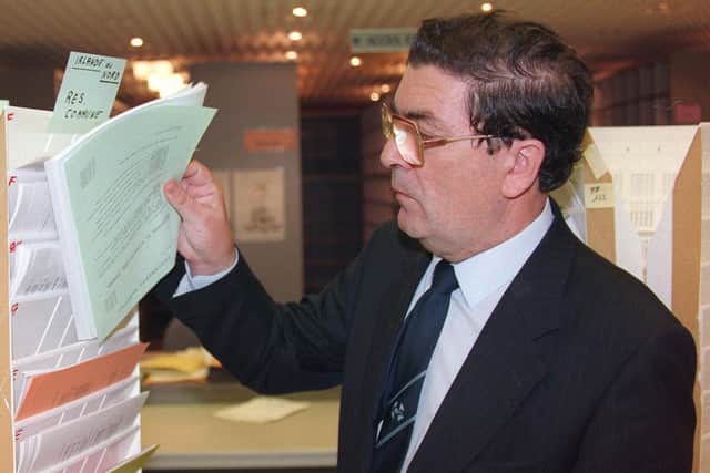 John Hume, looking through European Parliament's press releases in Strasbourg. (Photo credit should read JEAN-PHILIPPE KSIAZEK/AFP via Getty Images)