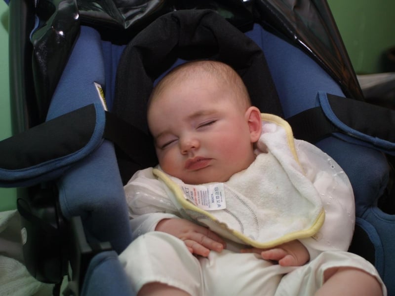 Baby Sam McGowan rests after all the excitement from his Christening Day.