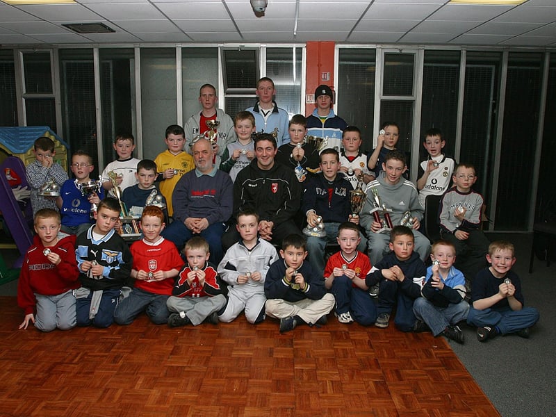 Derry City defender Peter Hutton (seated, centre) who was the special guest when he presented medals and Player of the Year awards at the presentation of prizes at the Don Boscos junior club's annual presentation of awards held at the Templemore Sports Complex.
