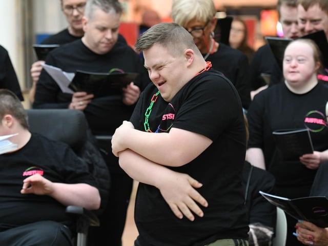 A member of the Just Us Choir from Enniskillen enjoys performing the the Foyleside Shopping Centre on Saturday.