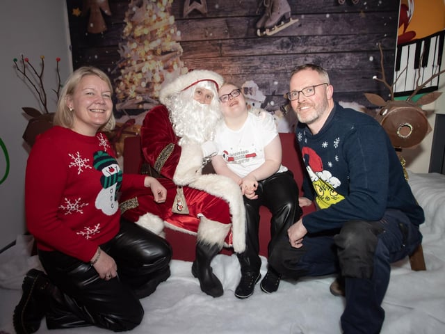 Ruby telling Santa what she would like for Christmas, accompanied by her mum and dad on Monday night.