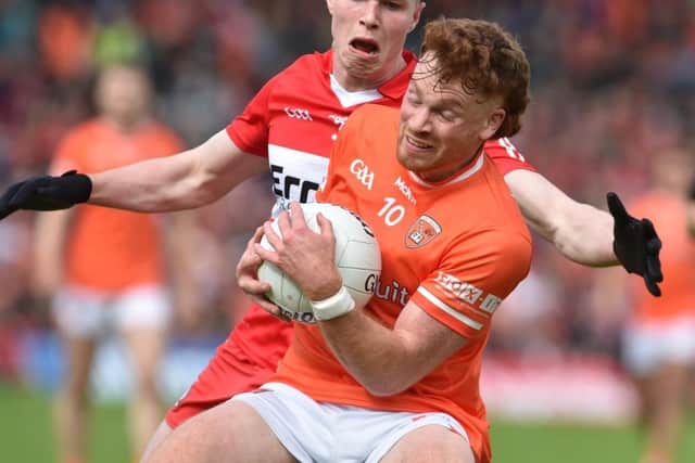Eoin McEvoy closes down Armagh's Jason Duffy during Sunday's Ulster Senior Football Final in Clones