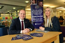 Communities minister Gordon Lyons with Make the Call outreach workers Angela Whyte (left) and Julie Taylor at a Make the Call outreach event in Carrickfergus Library