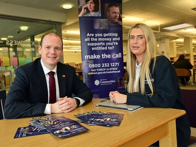 Communities minister Gordon Lyons with Make the Call outreach workers Angela Whyte (left) and Julie Taylor at a Make the Call outreach event in Carrickfergus Library