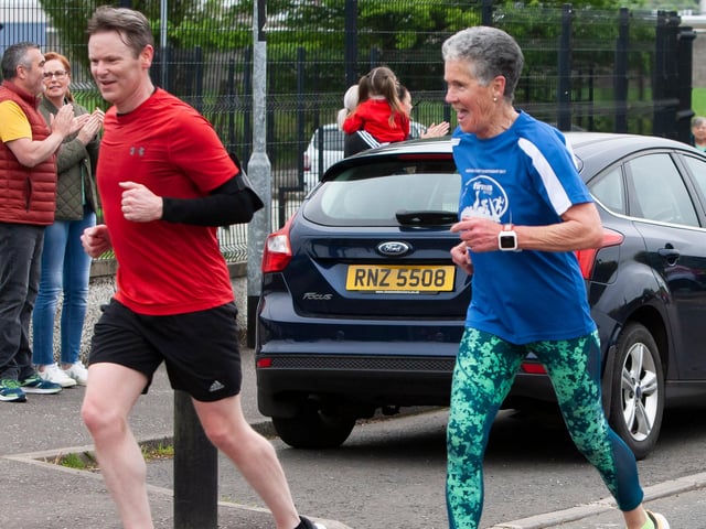 Legendary local runner and netball coach Roisin Lynch still manages to share a joke after completing 5km on Friday. On left is Hollybush governor Denis O’Donnell. (Photos: Jim McCafferty Photography)