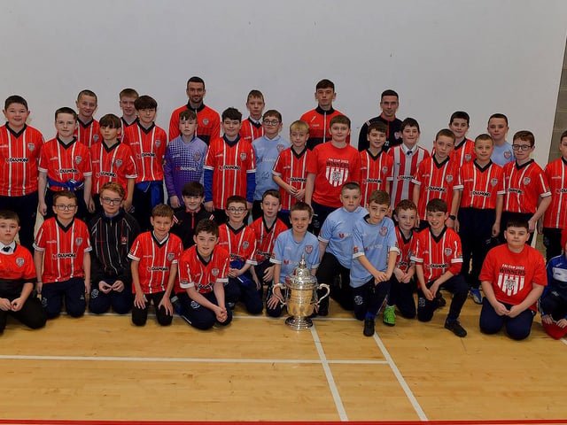 Derry City players Michael Duffy, Liam Mullan and Jordon McEneff pictured with St Columb's College Year 8 soccer players during a visit to the school, with the FAI Cup, on Monday. Photo: George Sweeney. DER2247GS - 20