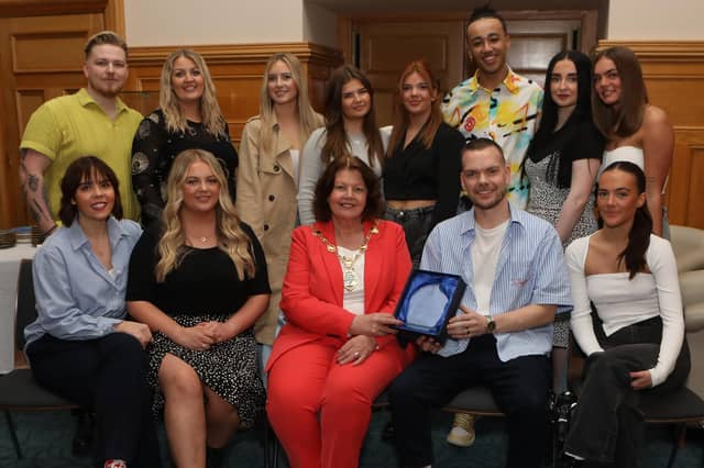 Atelier Hair Salon reception 1 - Mayor Patricia Logue presenting a piece of commemorative crystal to Ronan Stewart, to mark the success of Atelier Hair Salon winning the All Ireland Salon of the Year Competition. Included are members of staff. (Photo - Tom Heaney, nwpresspics)