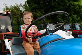 Dima pictured on a vintage tractor at the Muff Vintage Show, held in the Community Park on Sunday. Photo: George Sweeney.