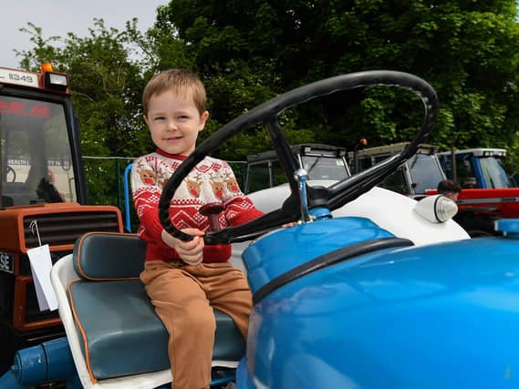 Dima pictured on a vintage tractor at the Muff Vintage Show, held in the Community Park on Sunday. Photo: George Sweeney.