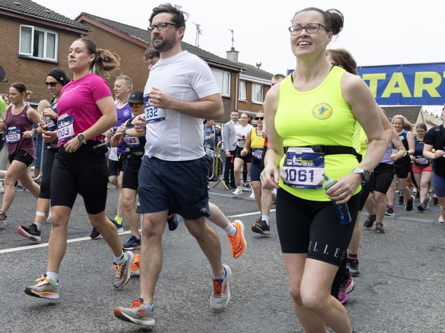 Kate McAree (1061) is all smiles at the Half Marathon. (Phot0: North West Newspix)