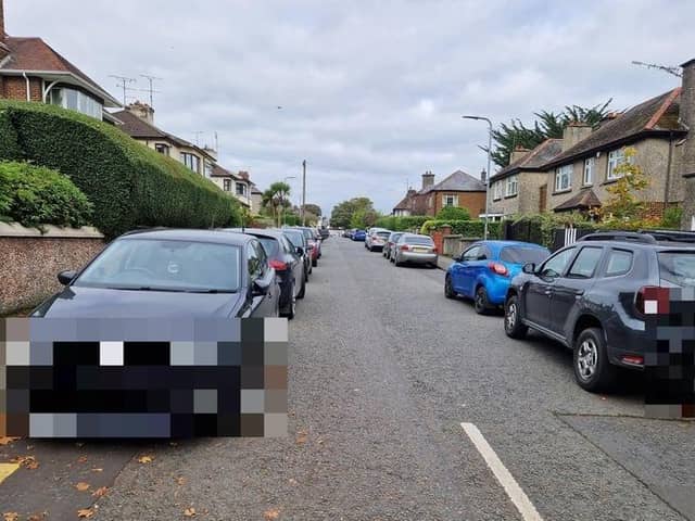 Cars lining the street along Aberfoyle Crescent South adjacent to the Magee College campus.