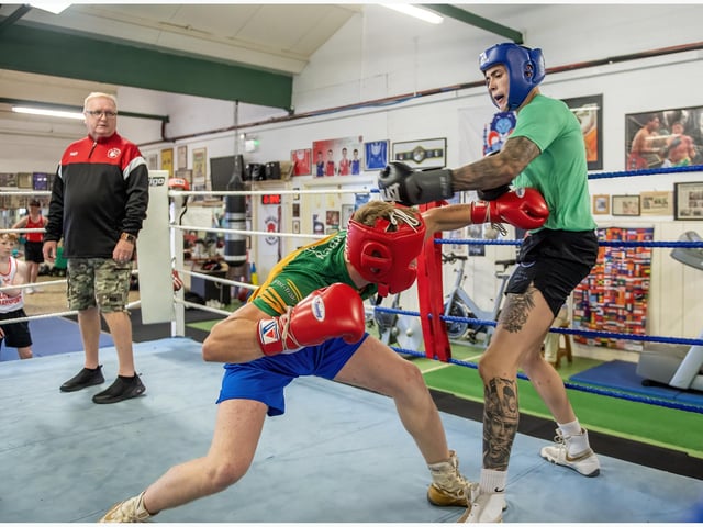 Good evasive skills shown here as Derry team manager Jim Knox watches on.