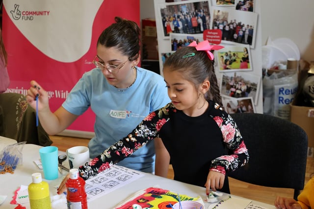 Youth leader Aoife offering Shanya a helping hand during the art programme.