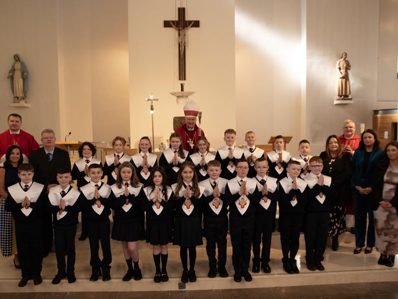 Pupils from Mr. Bill O'Donnell's P7 class at Holy Child Primary School who received the Sacrament of Confirmation from Bishop Donal McKeown at St. Mary's Church, Creggan on Friday last. Included in photo is Fr. Ignacio, Fr. McFaul, Mrs. Pat Concannon, Principal, Ms. Rebecca Campbell, Mrs. Aine O'Connor, Vice Principal and Ms. Aoife Doherty. (Photos: Jim McCafferty Photography)