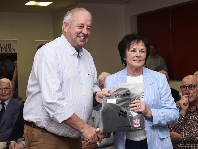 Derry County Chairman John Keenan makes a presentation to Mrs Kathleen Quinn, widow of the late Tom Quinn from Bellaghy at the 1975 / 76 Ulster SFC Winners' reunion in Find Insurance Owenbeg.