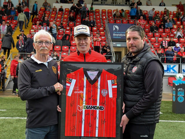 Tony O' Doherty and Ruaidhrí Higgins make a presentation of a signed Derry City shirt to James McClean to mark the milestone of his 100 cap for the Republic Ireland. Photograph: George Sweeney. DER2325GS – 68